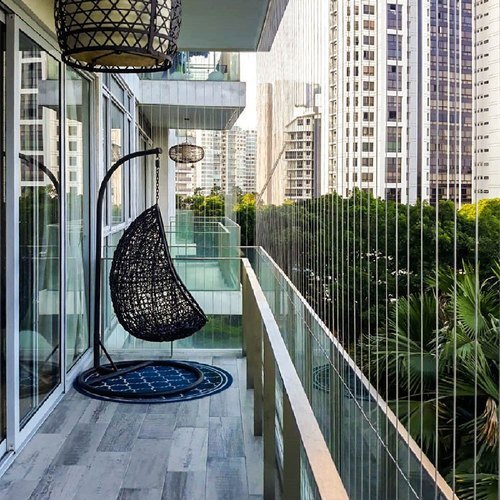 Technician installing an invisible grill on a Mumbai balcony